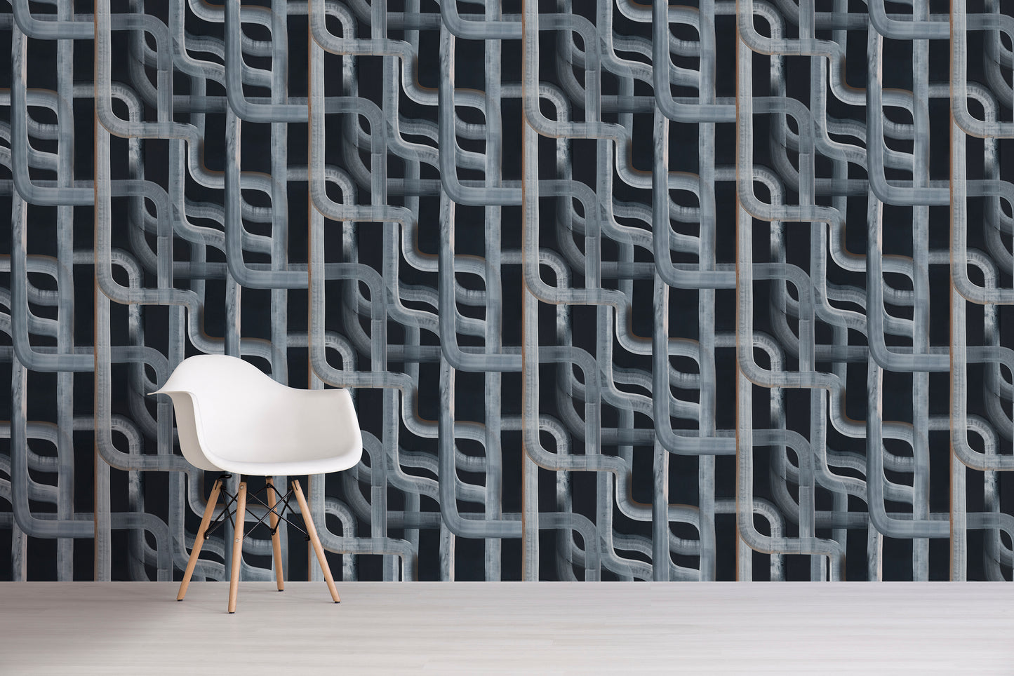 White chair in front of a textured, black patterned wall.