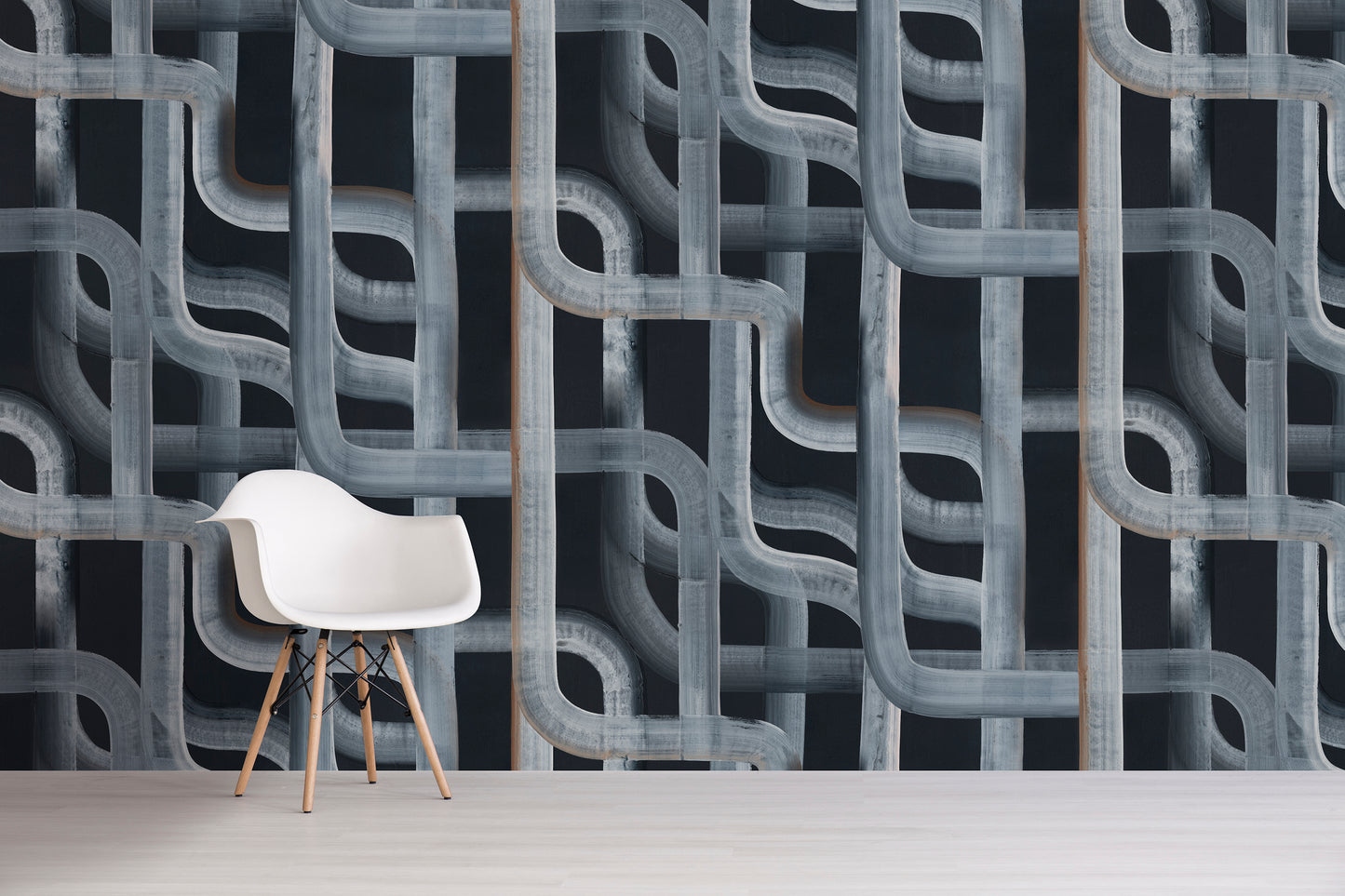 Modern chair in front of a black geometric patterned wall.