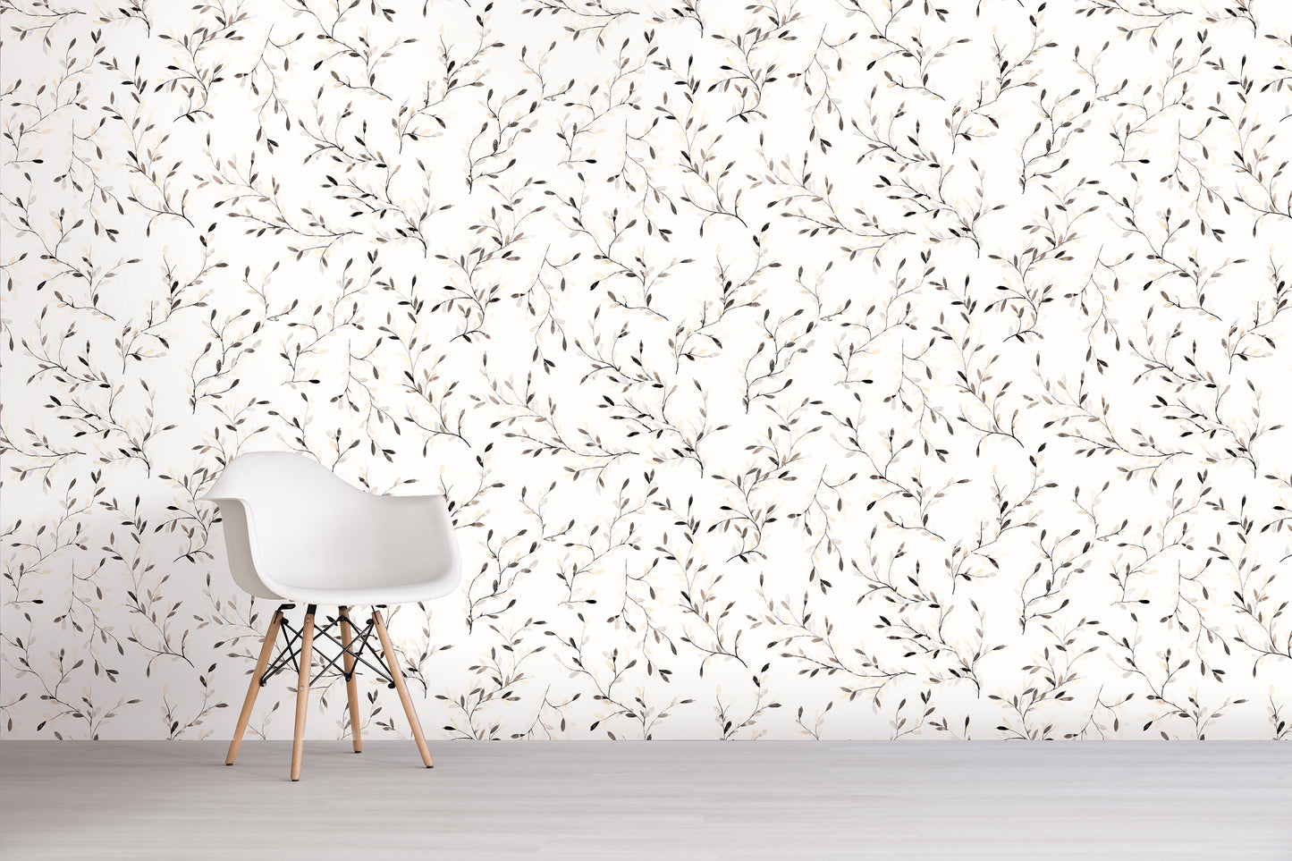 White chair against a wall with a subtle brown floral pattern