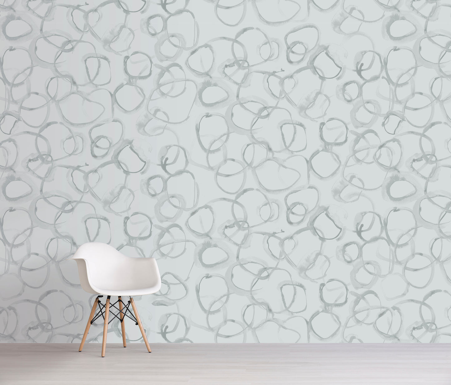 White chair in front of a wall with grey abstract pattern