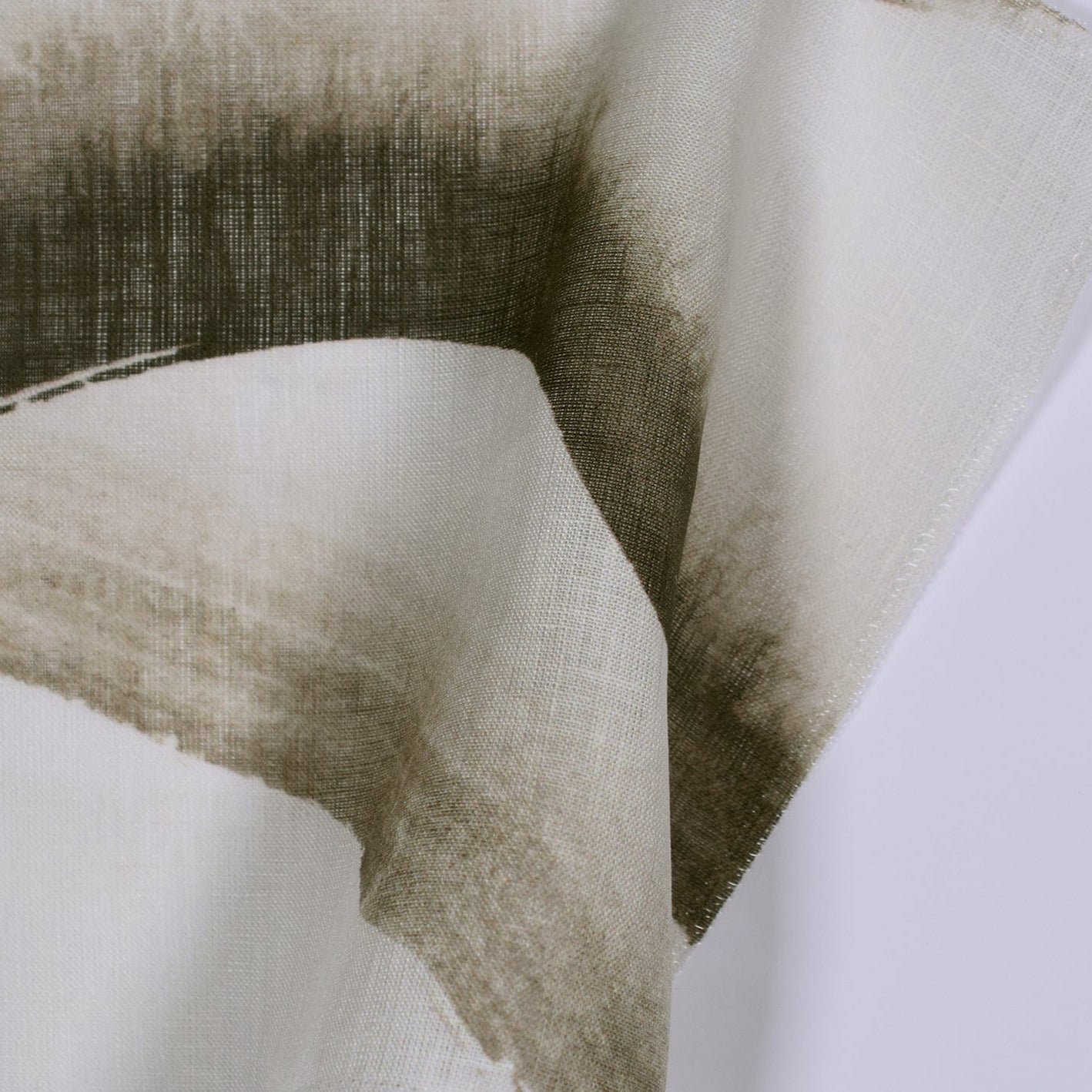 Brown brush stroke pattern on light sheer fabric