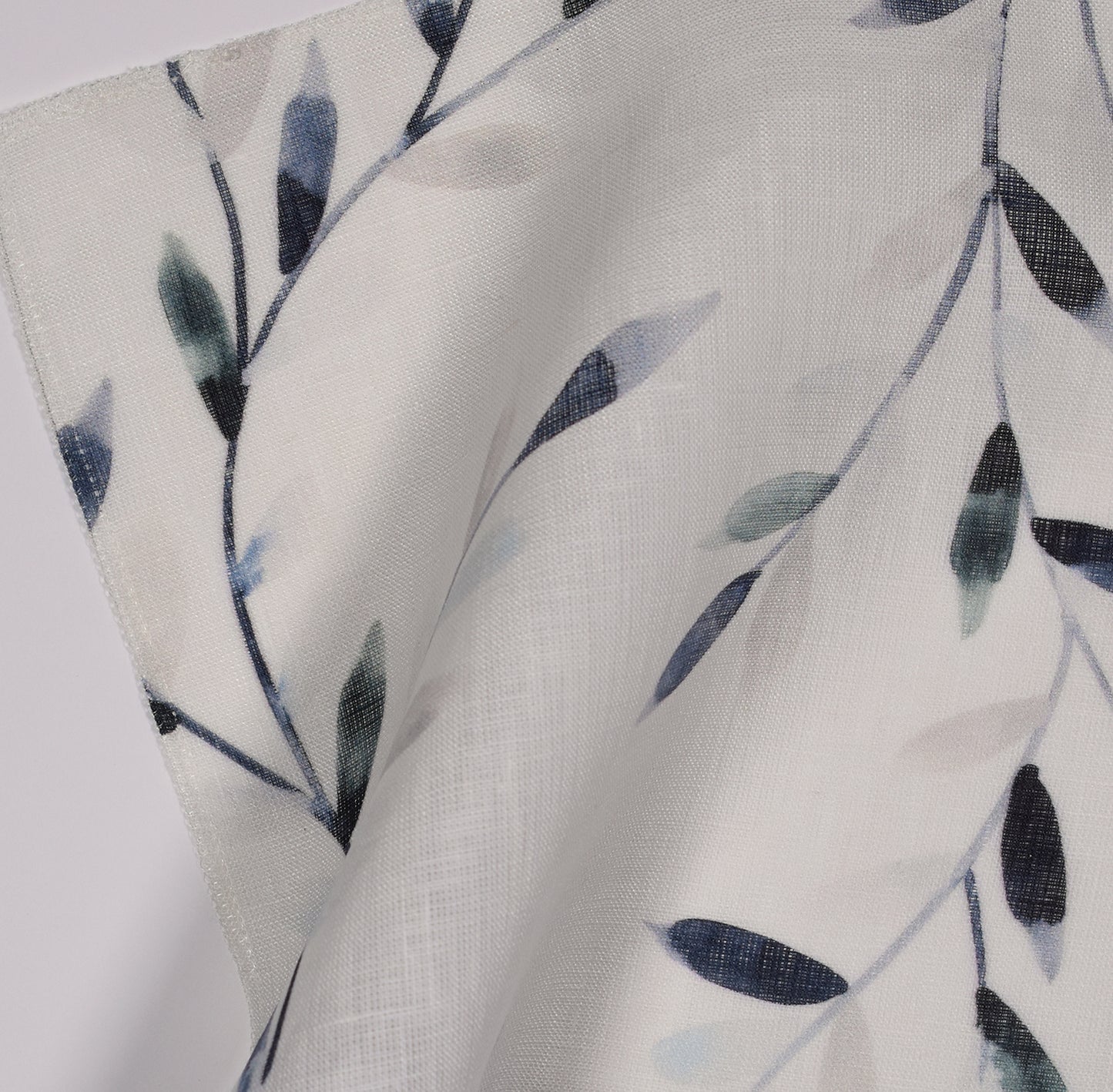 Fabric with blue leaf pattern on light sheer fabric