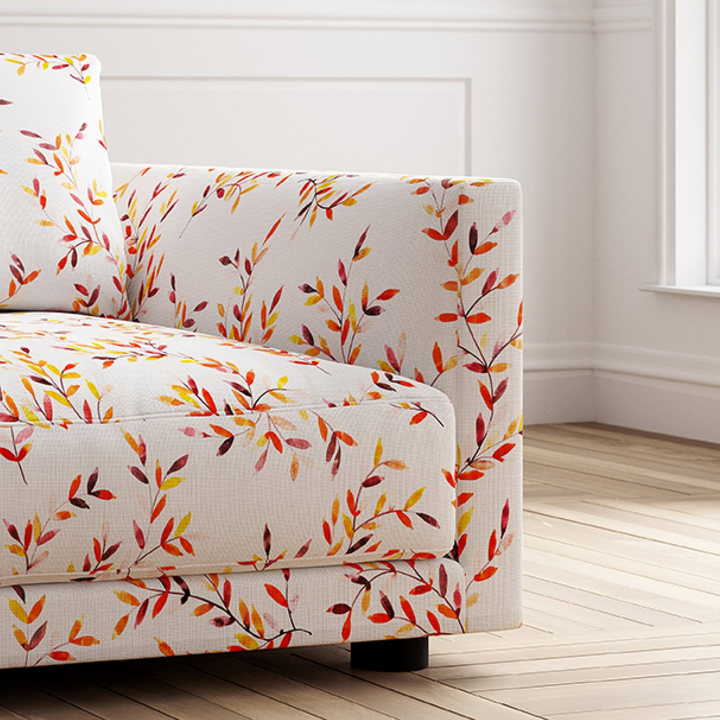 Sofa with colorful leaf pattern in a room with wooden floor and white walls