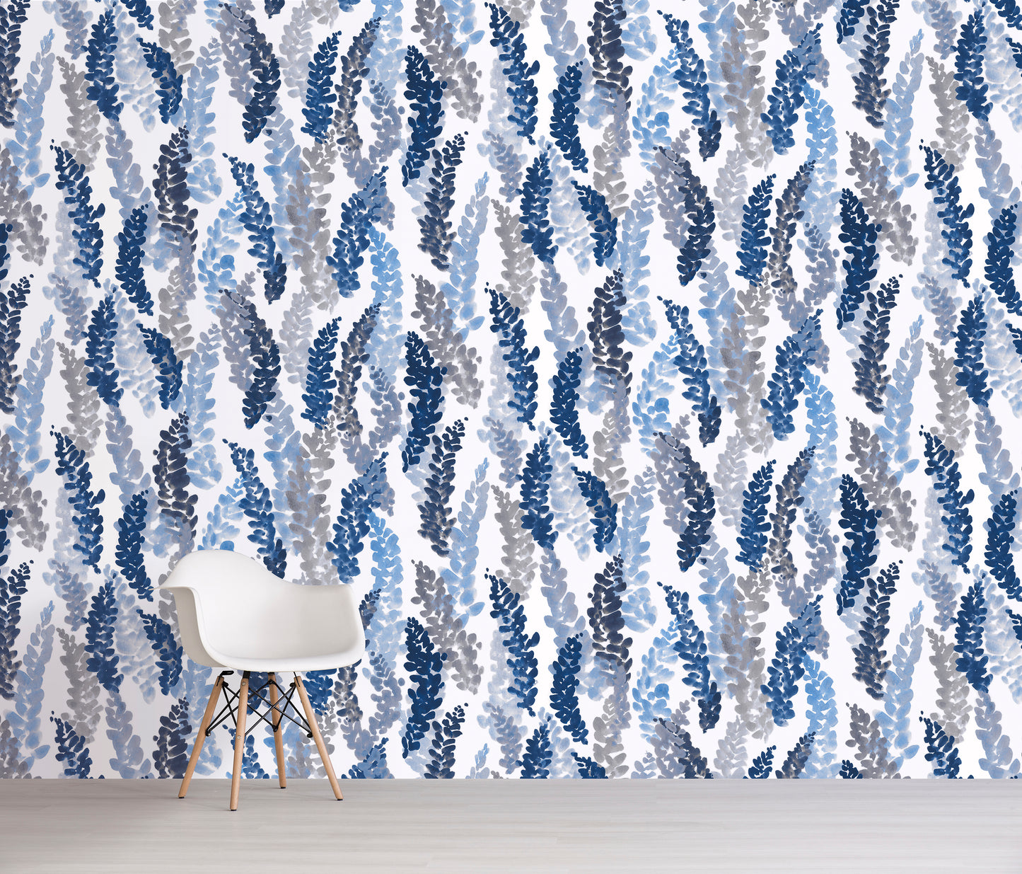 Wallpaper with blue and gray leaf pattern in a room with a chair.