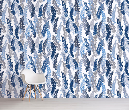 Wallpaper with blue and gray leaf pattern in a room with a chair.
