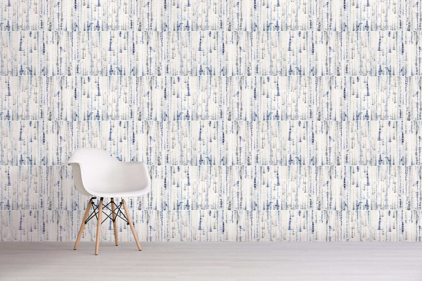 White chair against a textured blue and white wall.