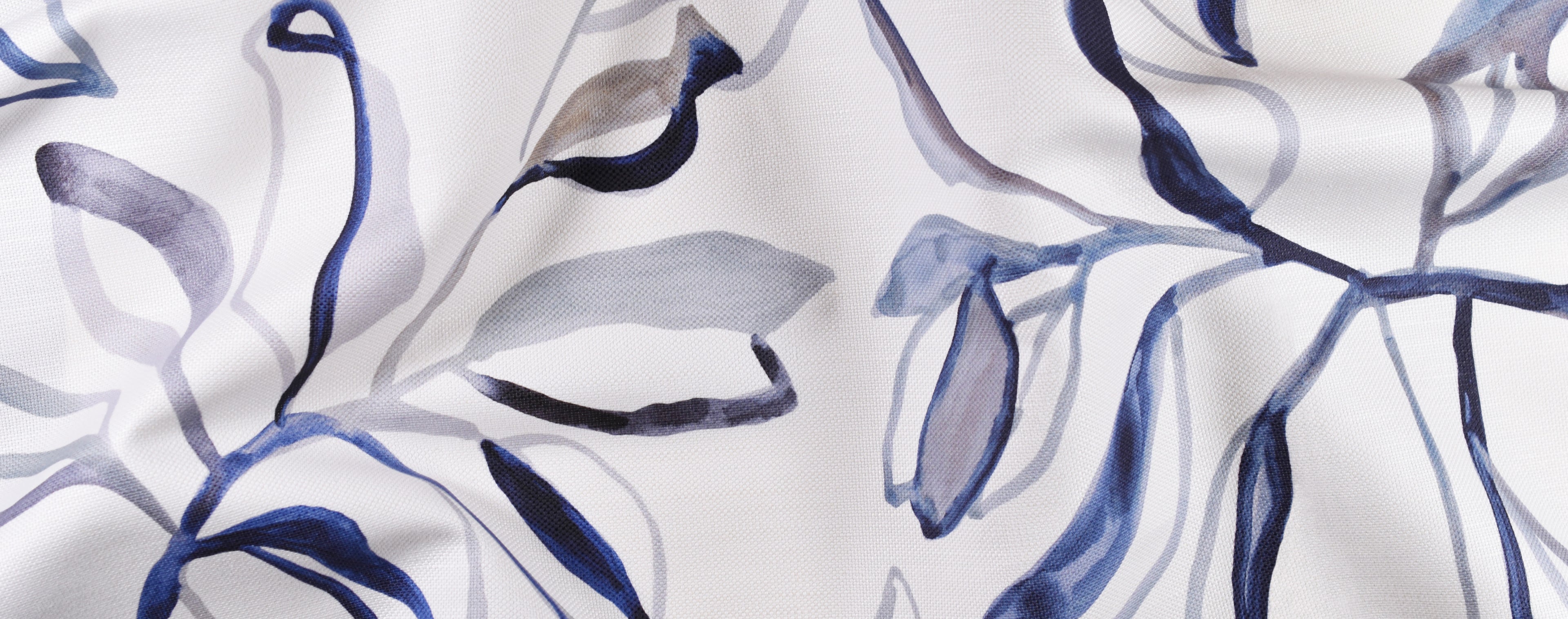 Close-up of fabric with blue and gray abstract leaf pattern on white background