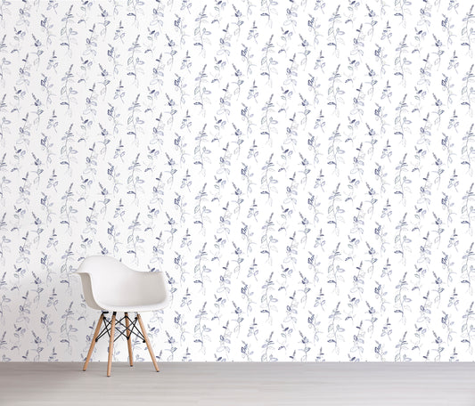 White chair in front of a wall with lavender floral patterned wallpaper