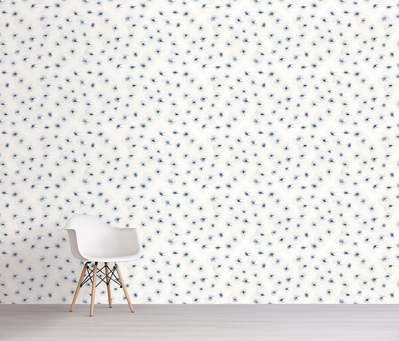 White chair in front of a wall with a subtle blue pattern