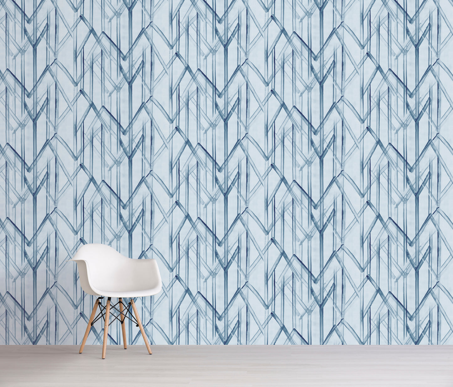 White chair in front of a wall with blue geometric pattern