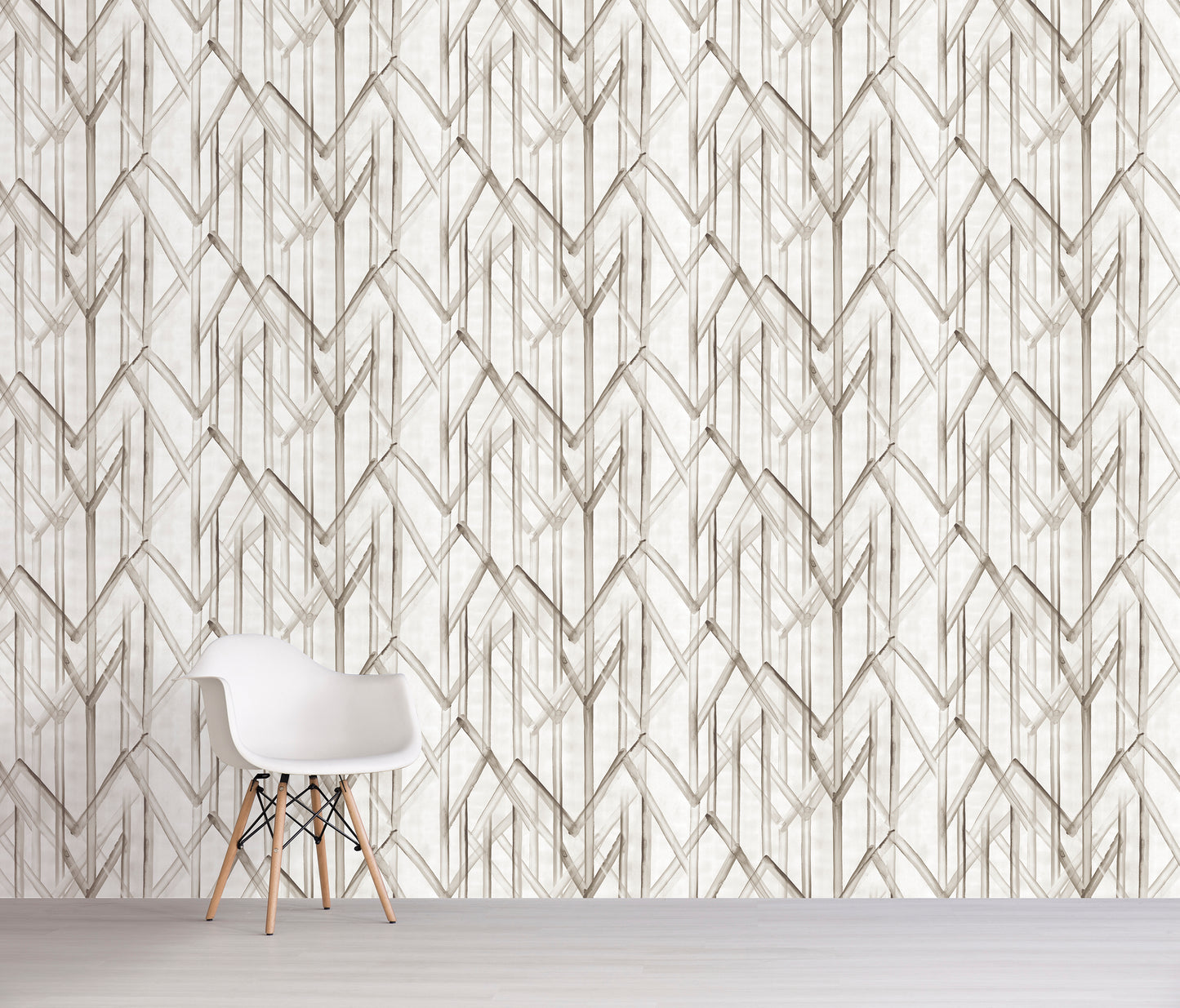 Geometric tan patterned wall paper with a white chair in front