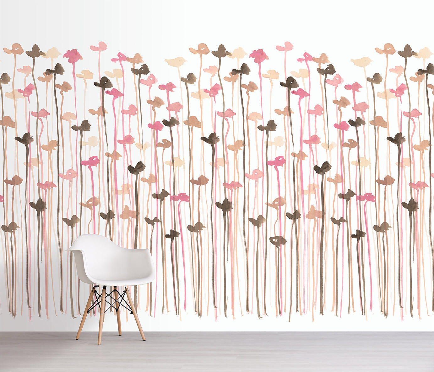 Wallpaper with floral pattern in pink and brown on a white wall with a chair in front.
