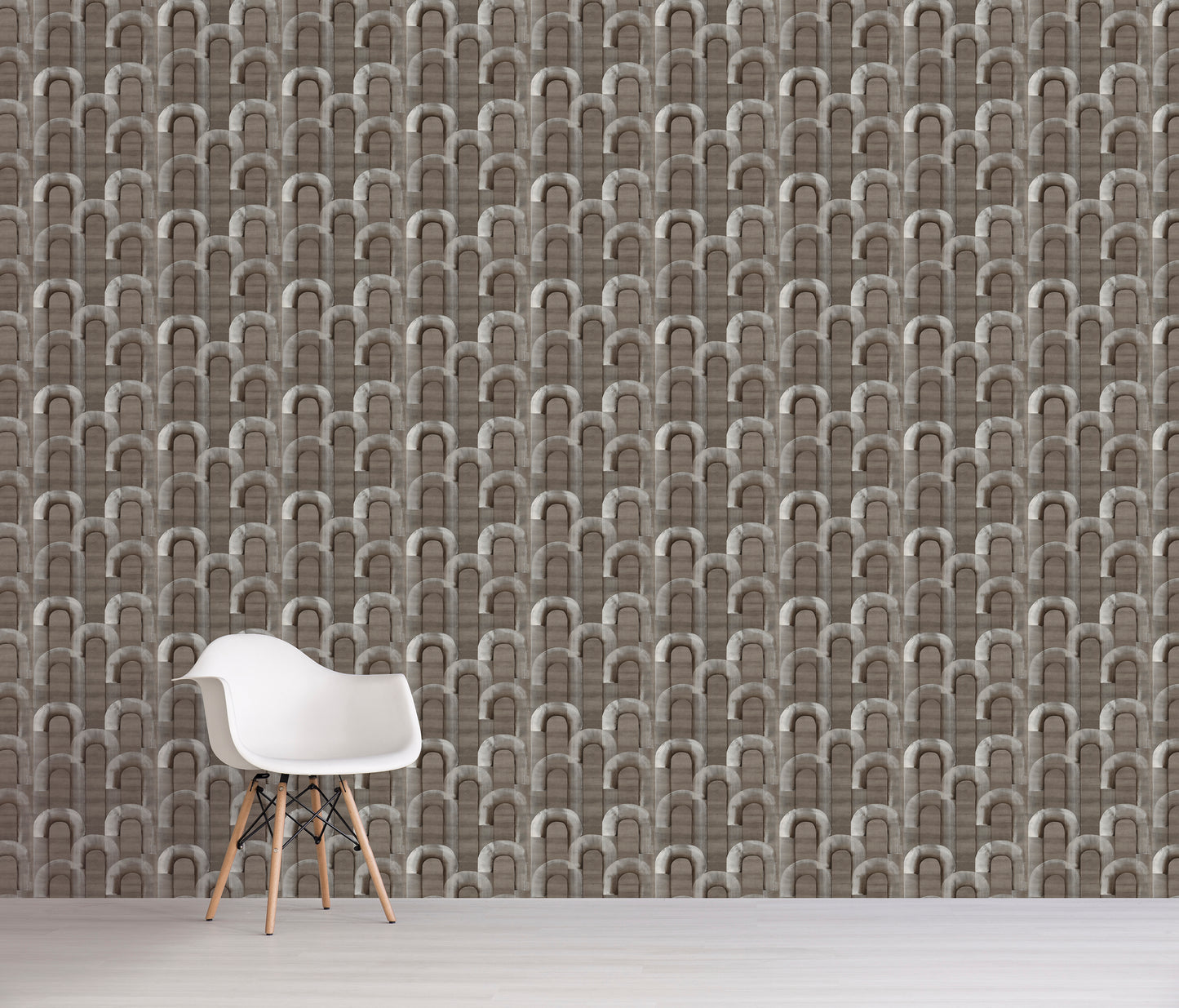 White chair in front of a wall with gray geometric patterned wallpaper