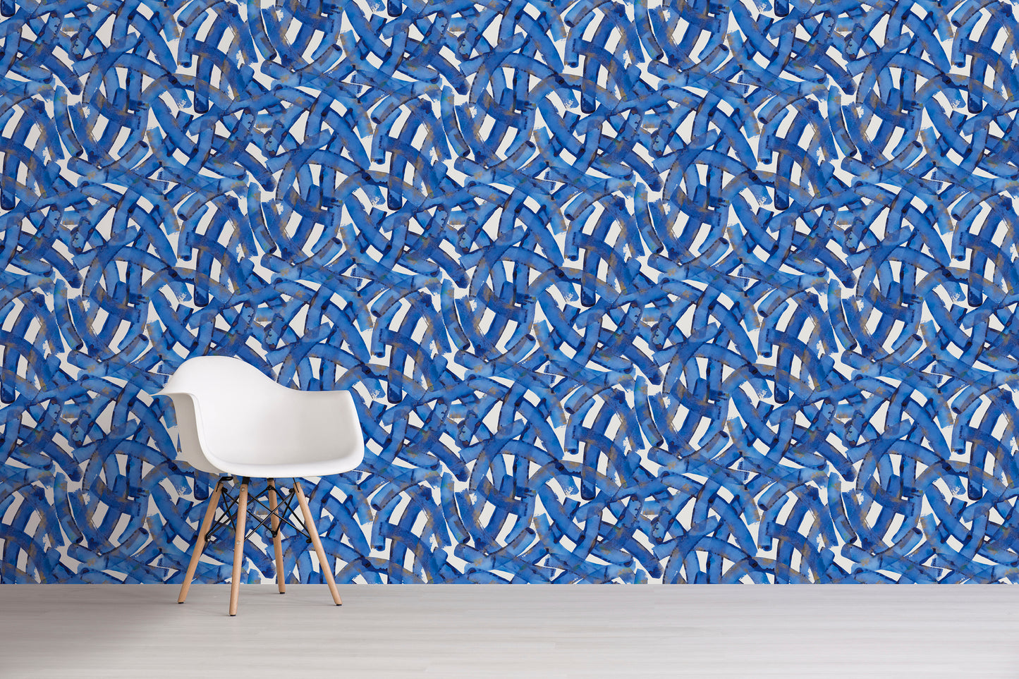 White chair in front of a blue abstract patterned wall.