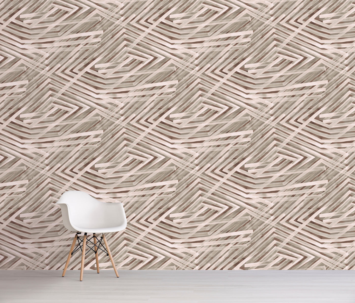 White chair in front of a wall with brown geometric patterned wallpaper