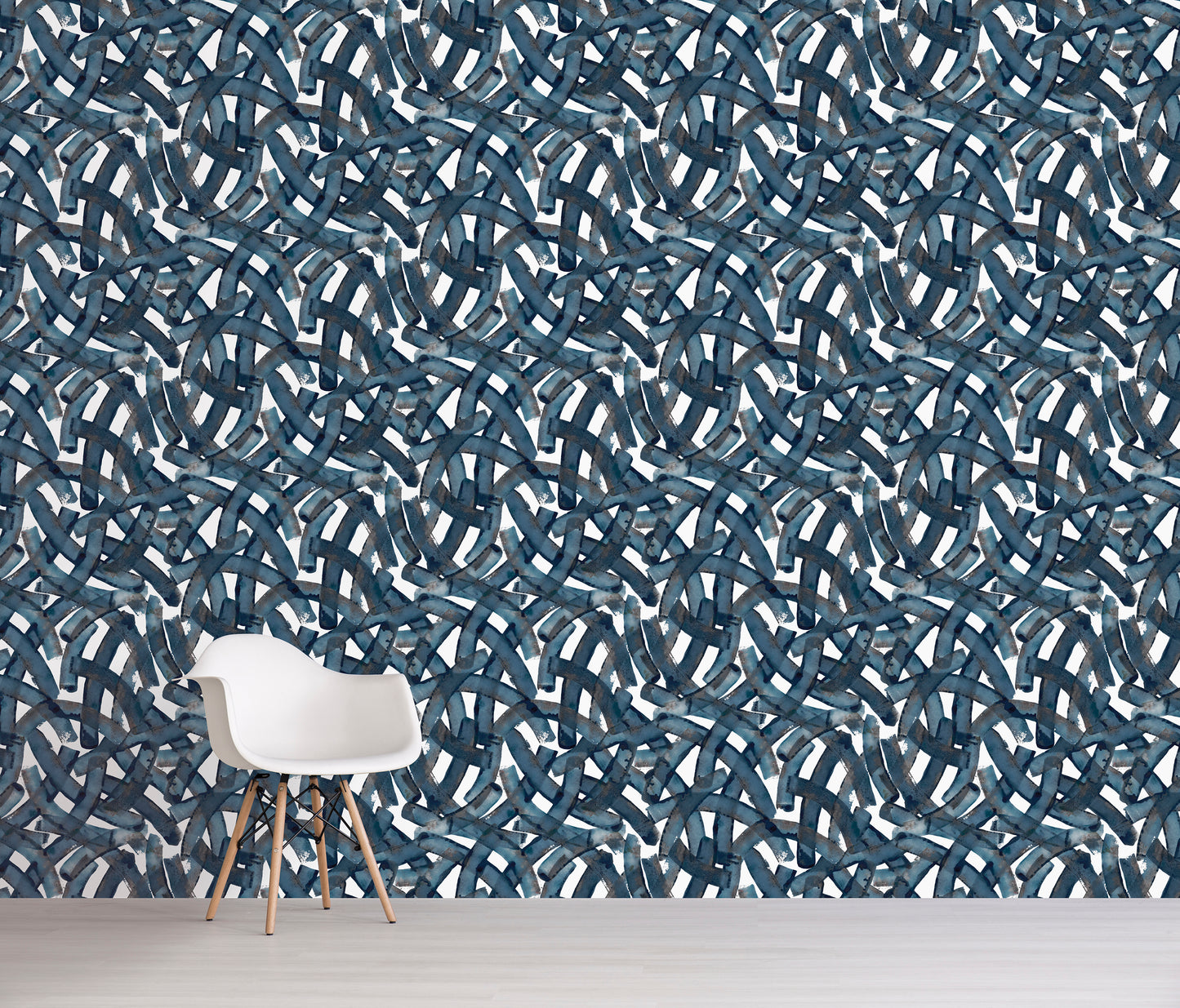 Wall with blue abstract pattern and a white chair in front