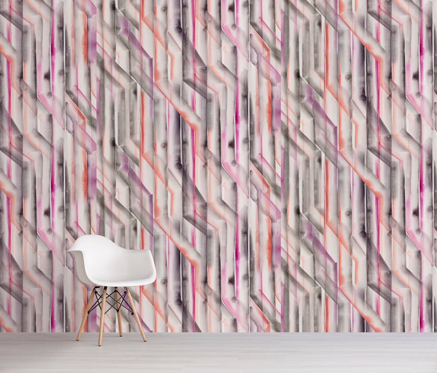 Geometric pink and orange patterned wall with a white chair in front