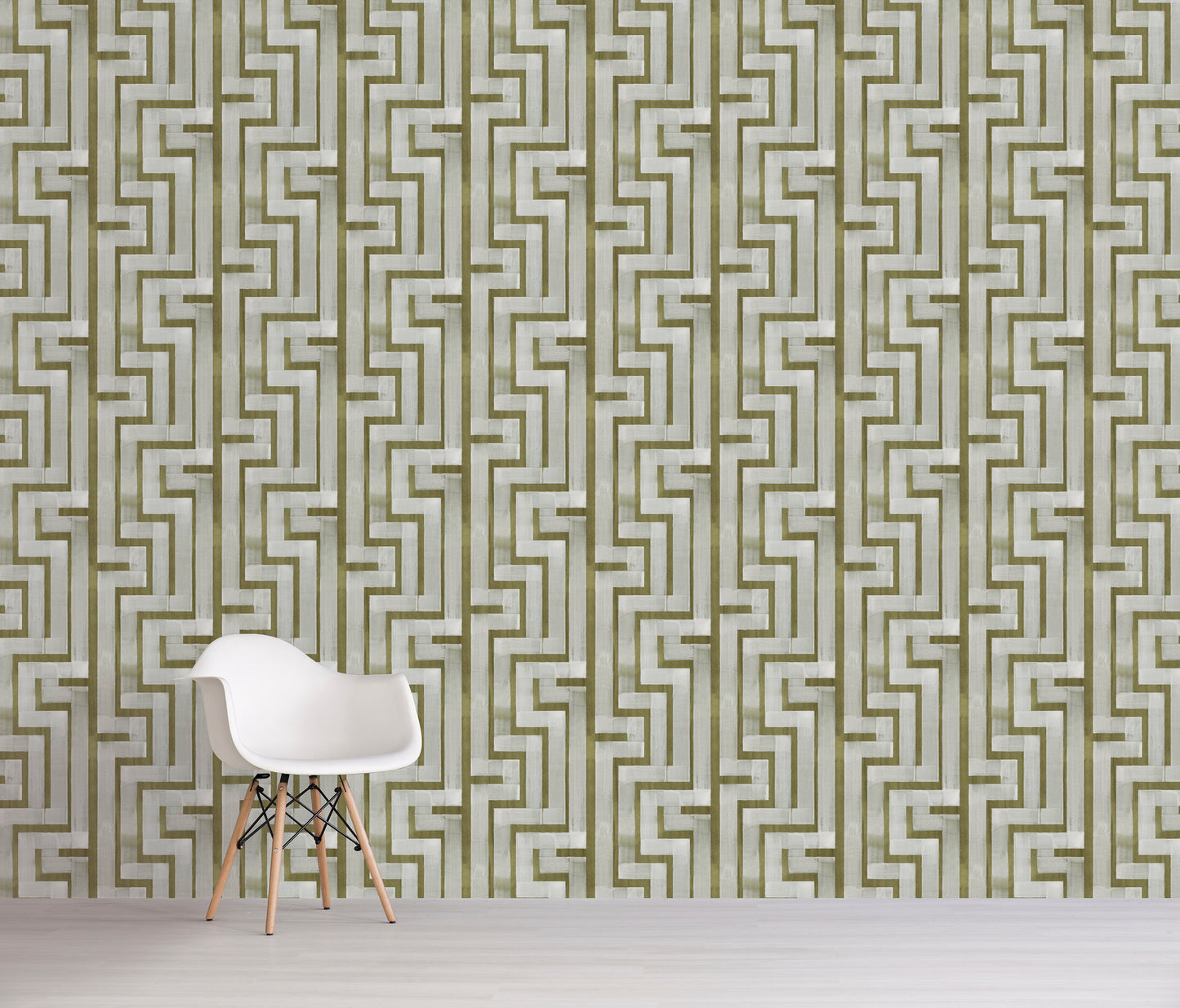 White chair in front of a green geometric patterned wall.