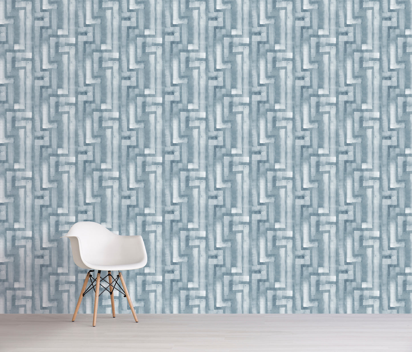 White chair in front of a blue geometric patterned wall.