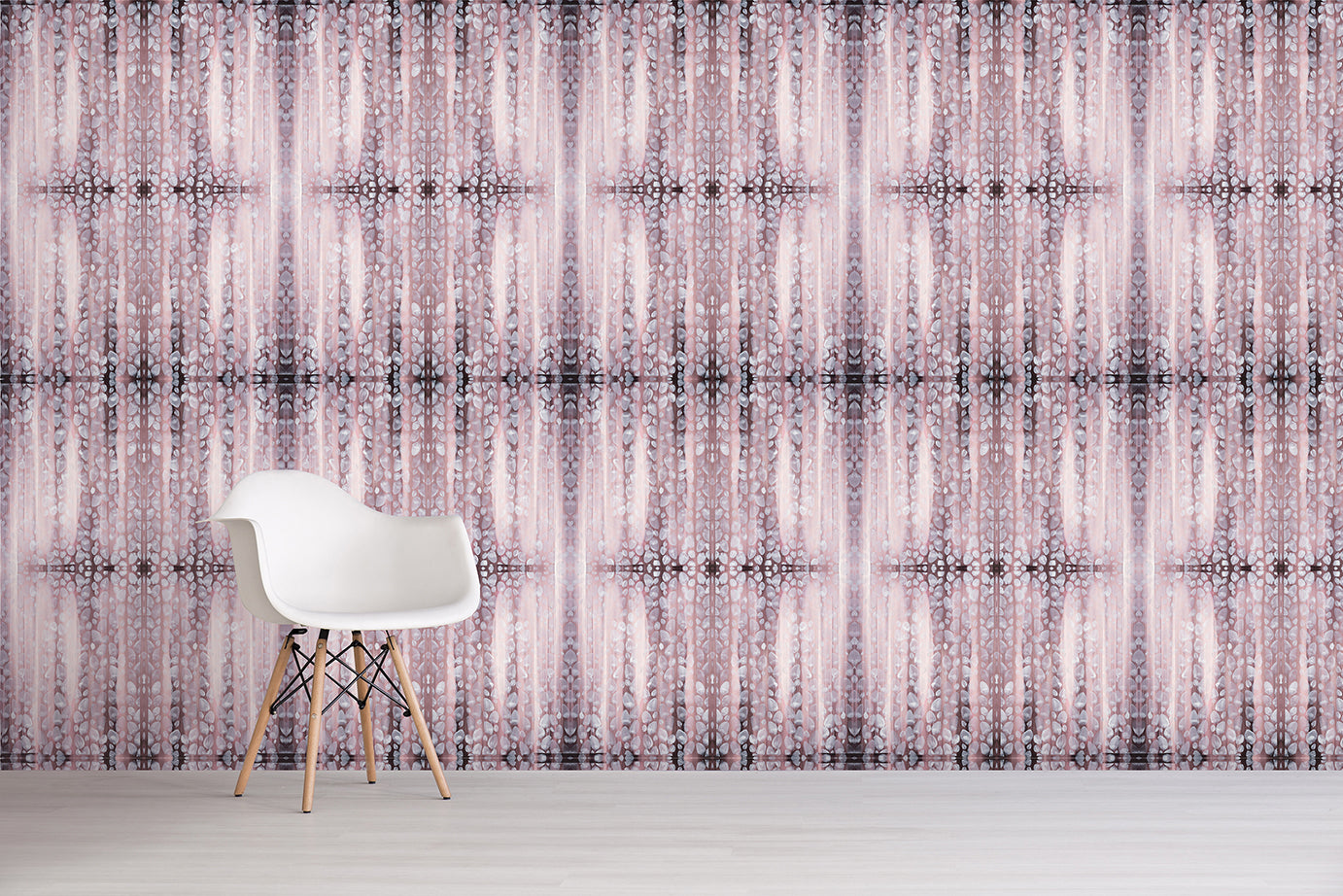 White chair in front of a patterned wall with a pink design.