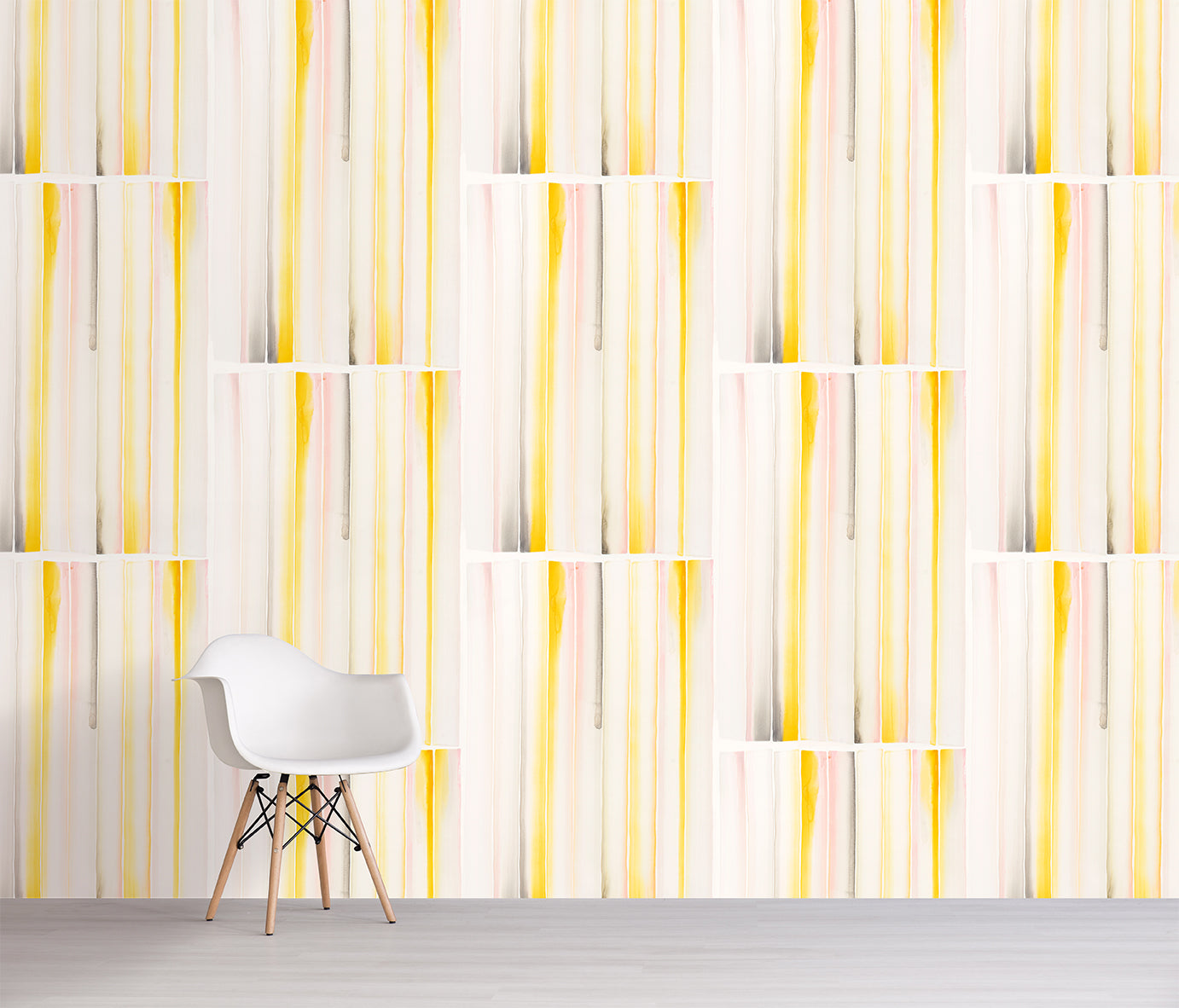 Wallpaper with a pattern of vertical stripes in yellow and pink pastel colors with a white chair in front.
