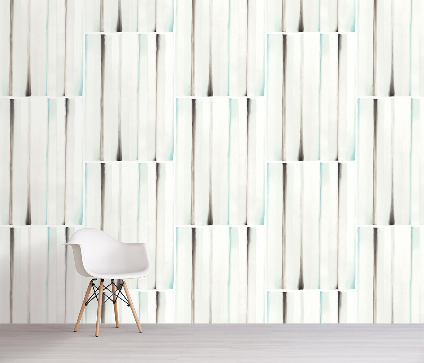 White chair in front of a wall with a modern ice green and gray stripes.