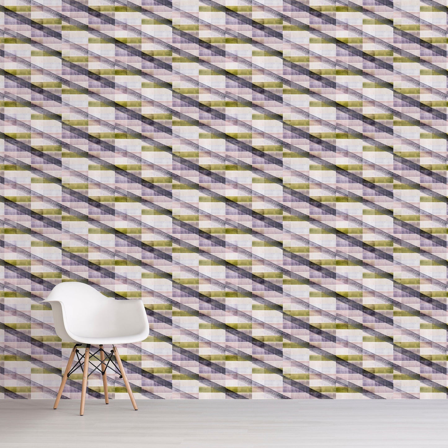 Patterned wall with geometric design in green, purple, and white, featuring a white chair in front.