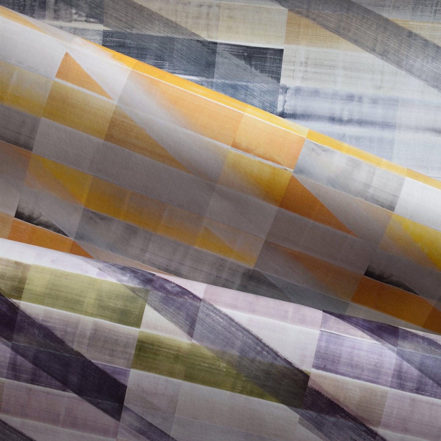 Close-up of patterned fabric with geometric design in yellow, purple, and gray.