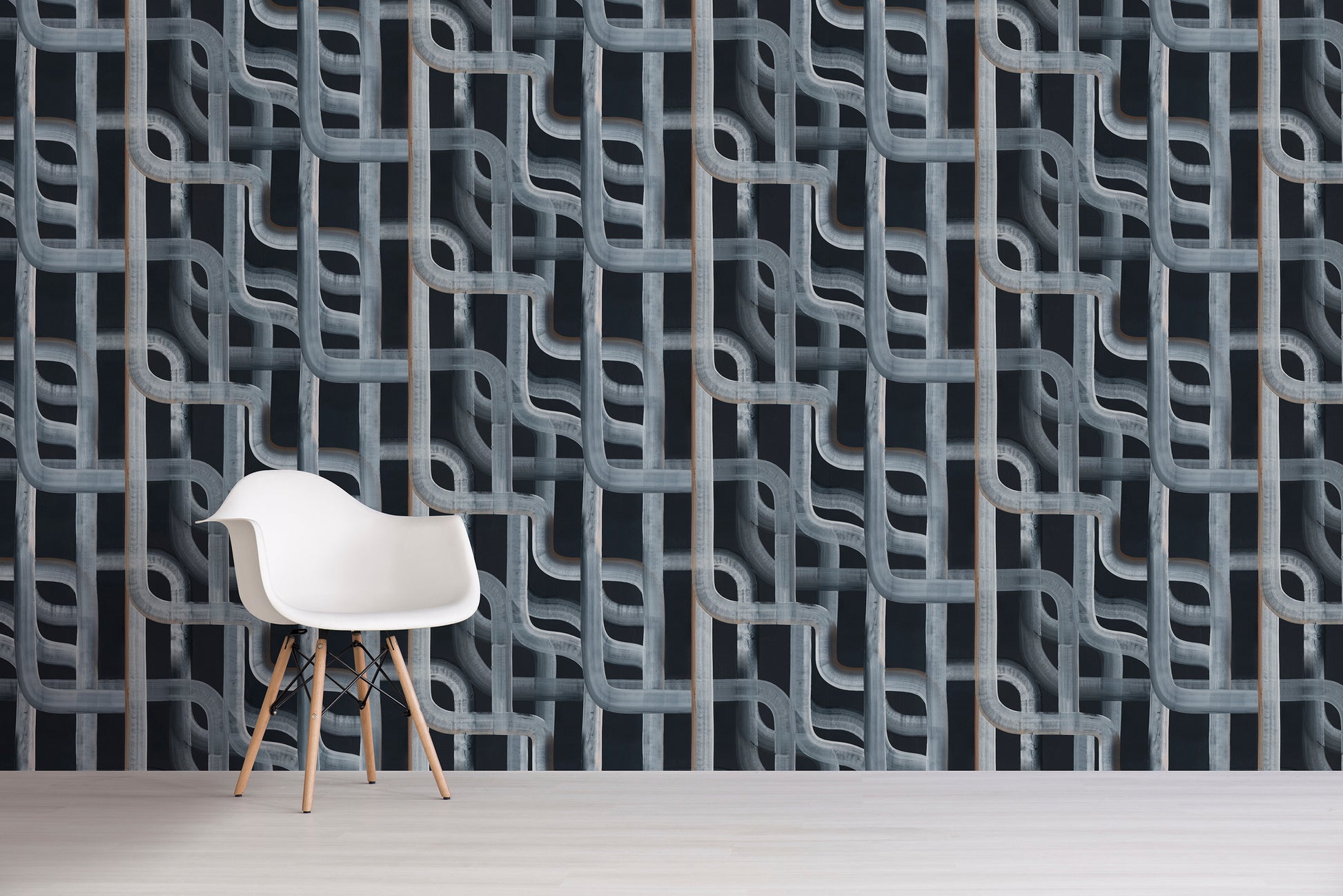 White chair in front of a textured, black patterned wall.