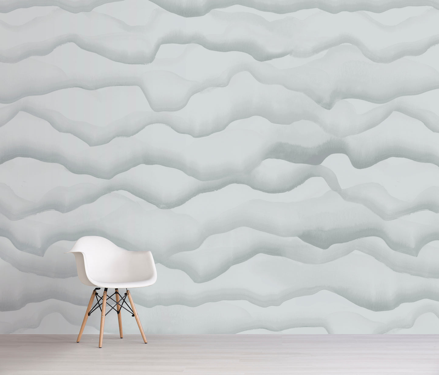 White chair in front of a gray textured wall with wavy patterns