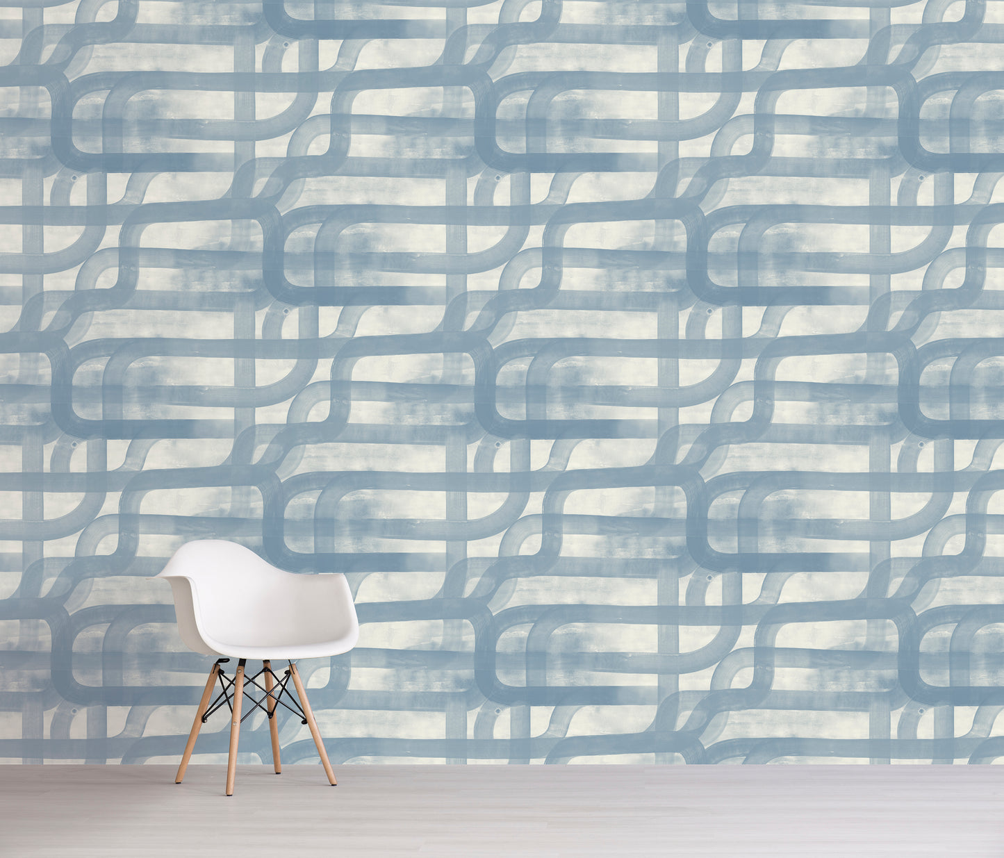 White chair in front of a wall with abstract blue and gray pattern