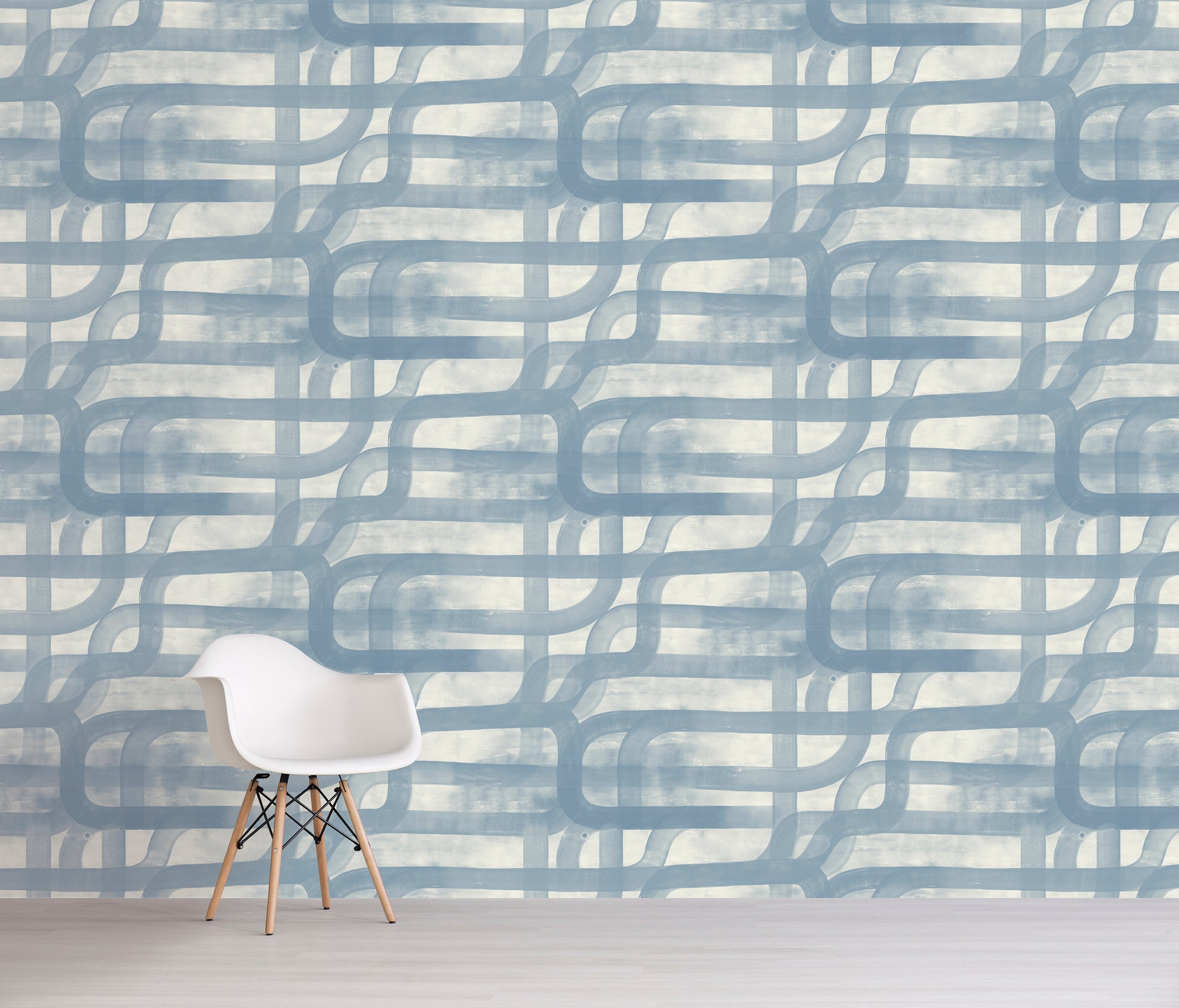 White chair in front of a wall with abstract blue and gray pattern