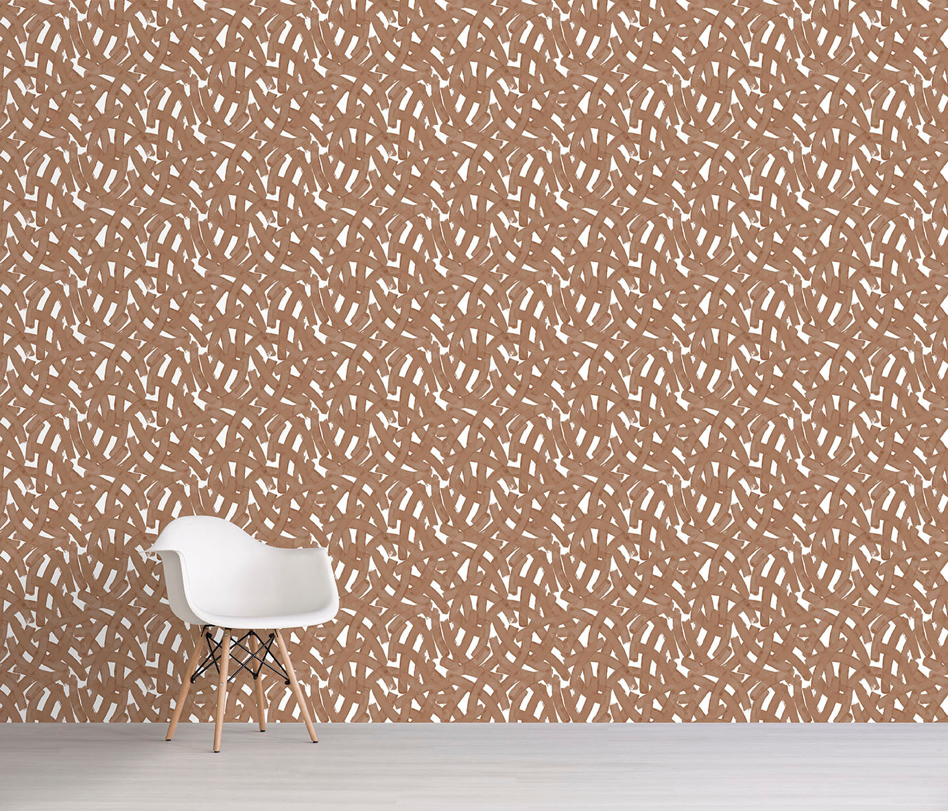 Brown abstract patterned wallpaper with a white chair in front