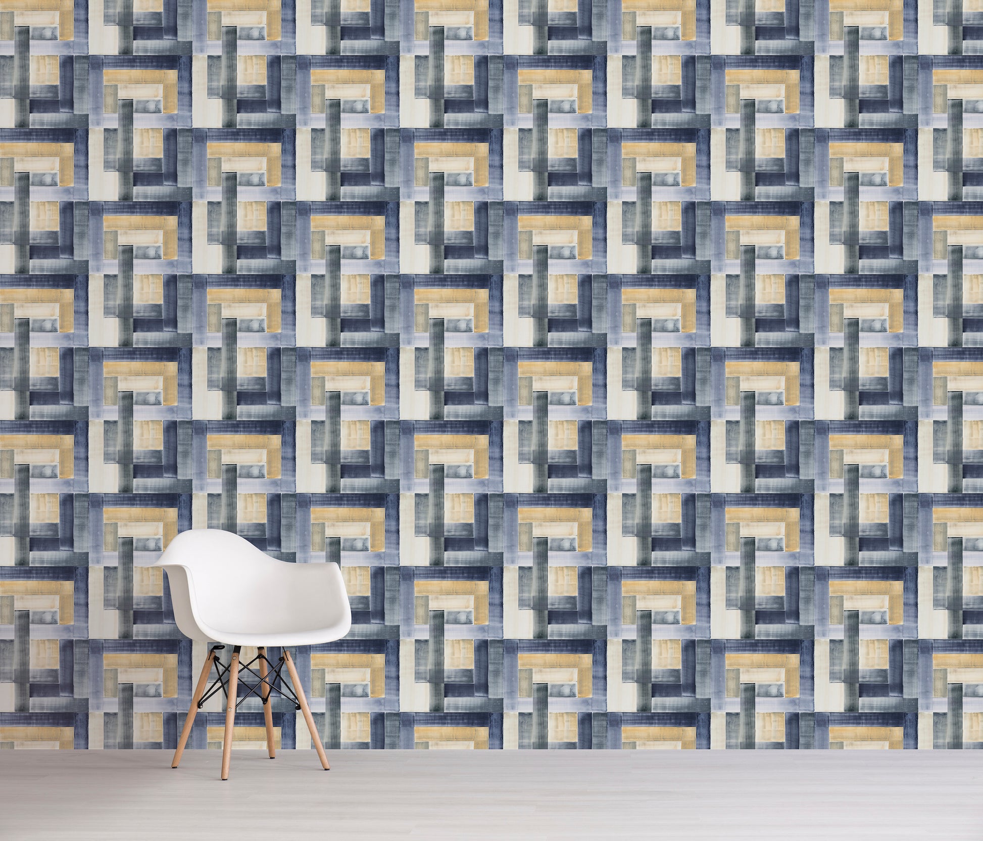 Geometric blue and tan patterned wall with a white chair in front