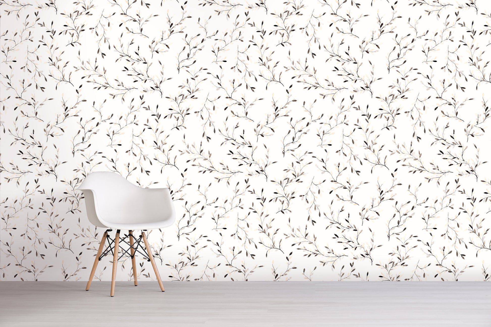 White chair against a wall with a subtle brown floral pattern