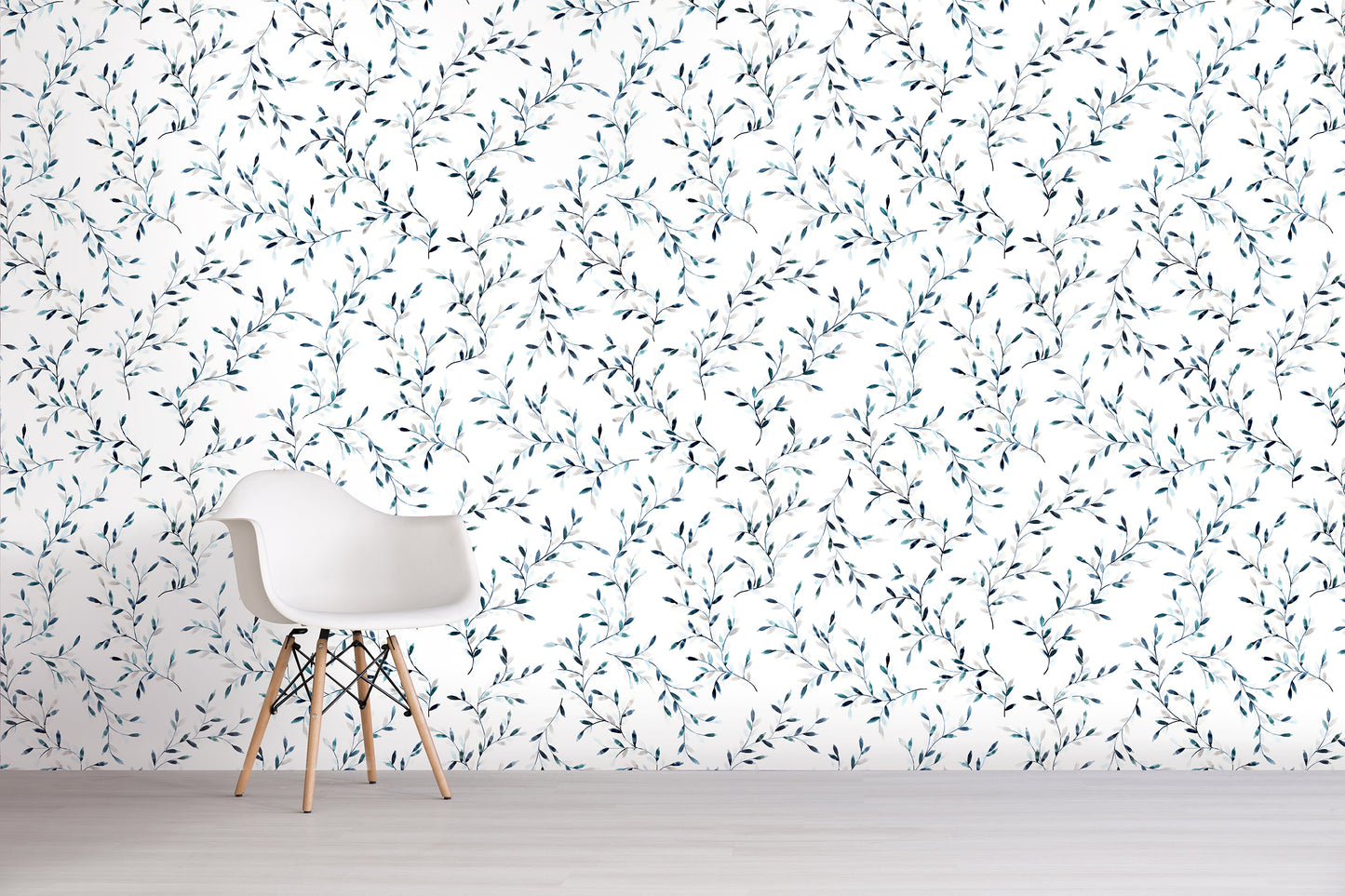White chair in front of a wall with a subtle blue floral pattern