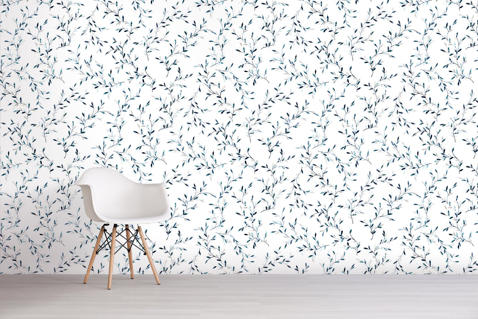 White chair in front of a wall with a subtle blue floral pattern