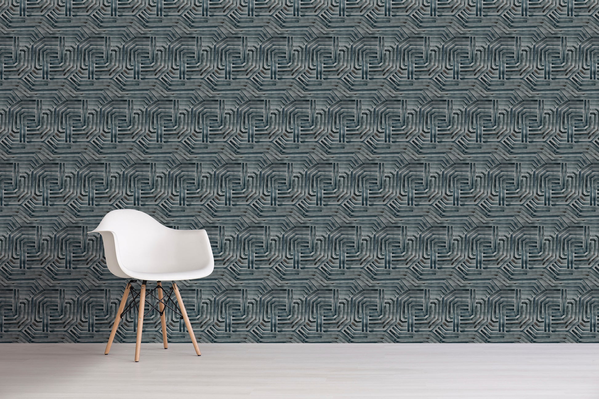 White chair in front of a textured gray wall with geometric pattern
