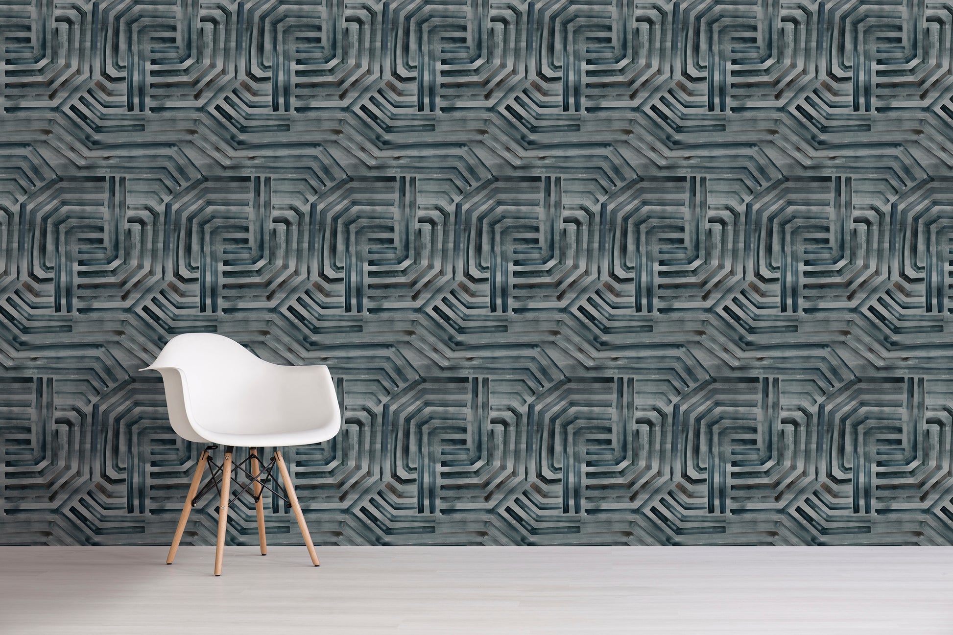 White chair in front of a textured wall with grey geometric pattern