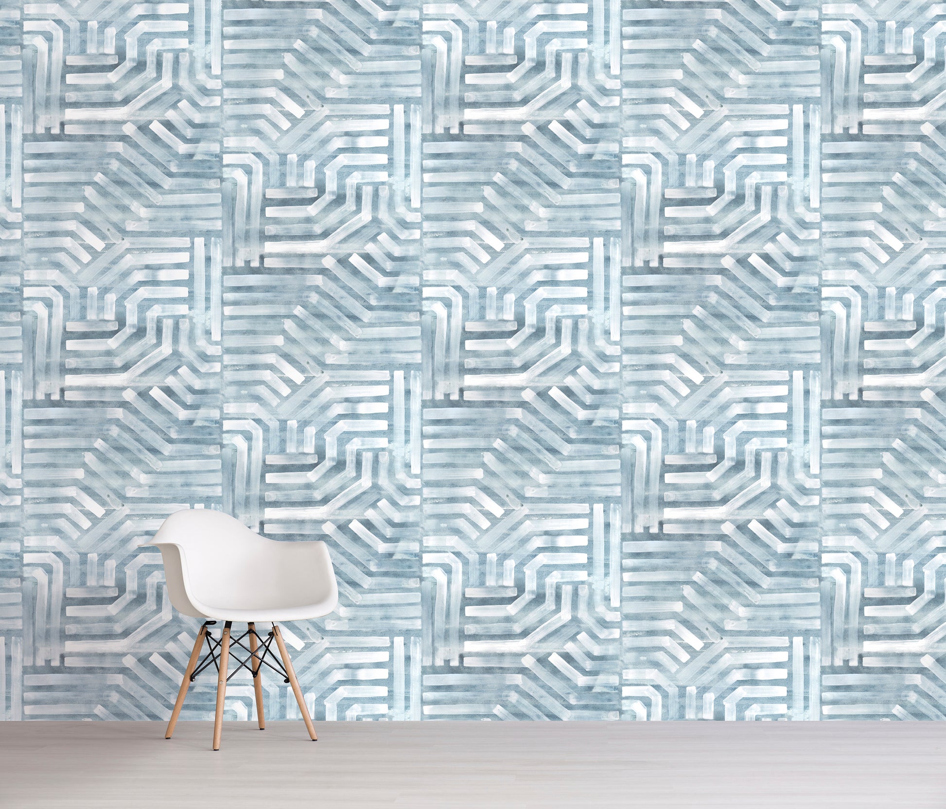 Geometric blue patterned wall with a chair in front
