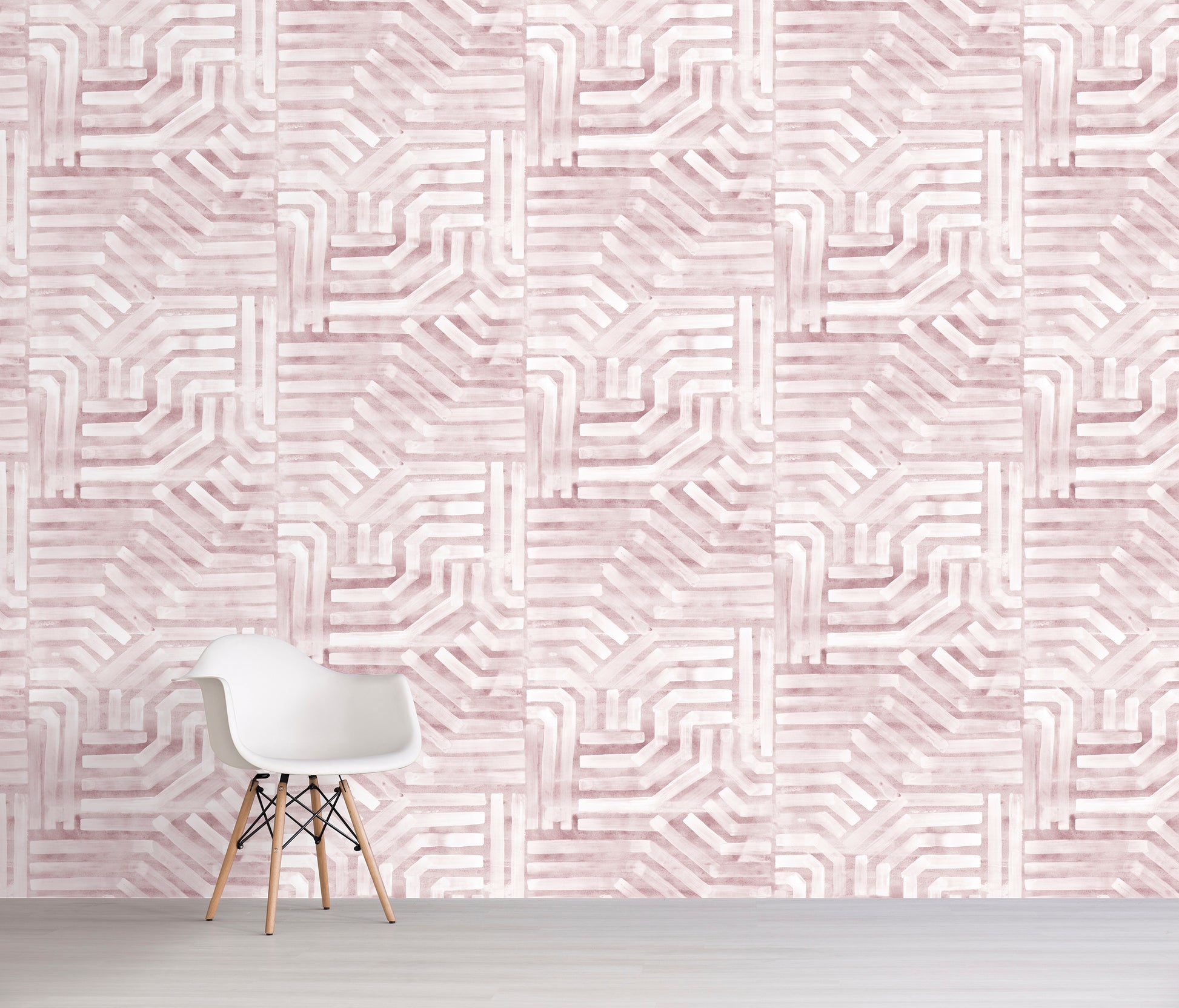 White chair in front of a wall with pink geometric pattern