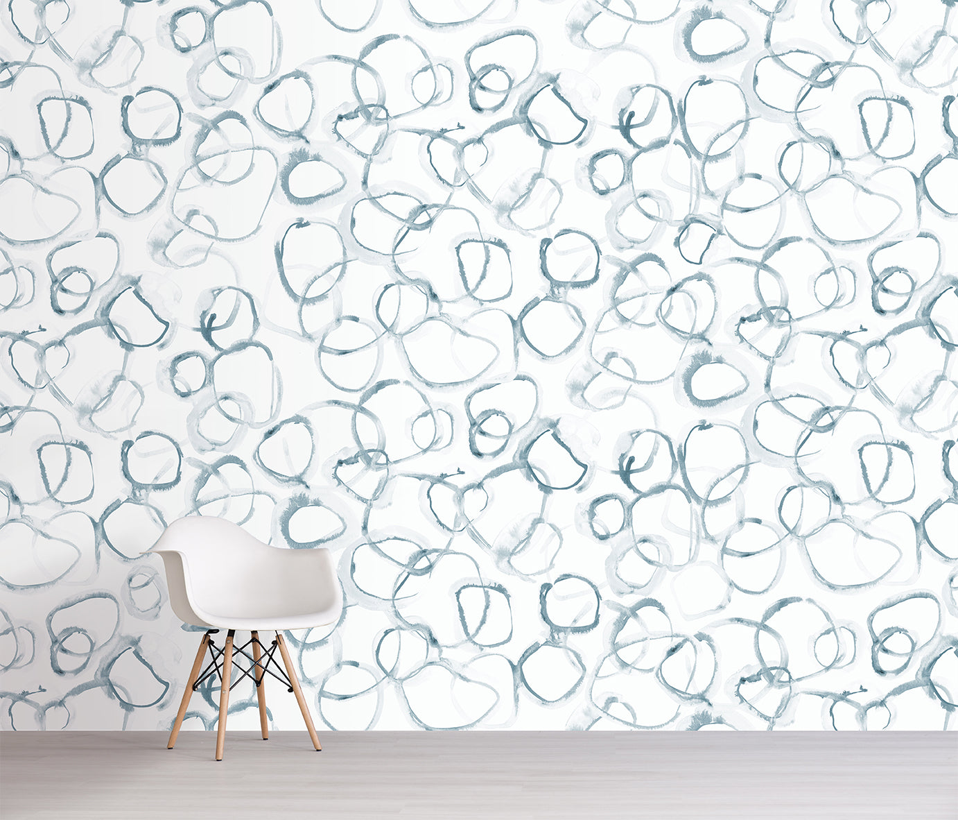 Wallpaper with abstract blue shapes on a white background, featuring a chair in front.