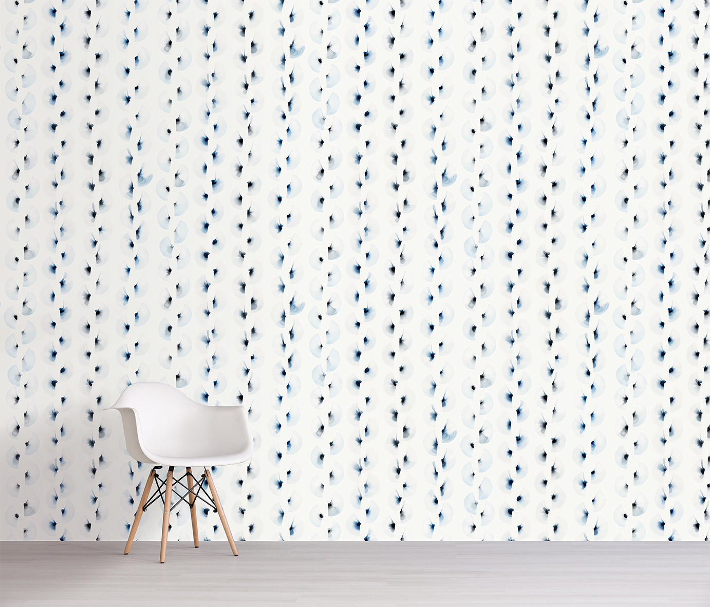 White chair in front of a wall with blue and black abstract pattern