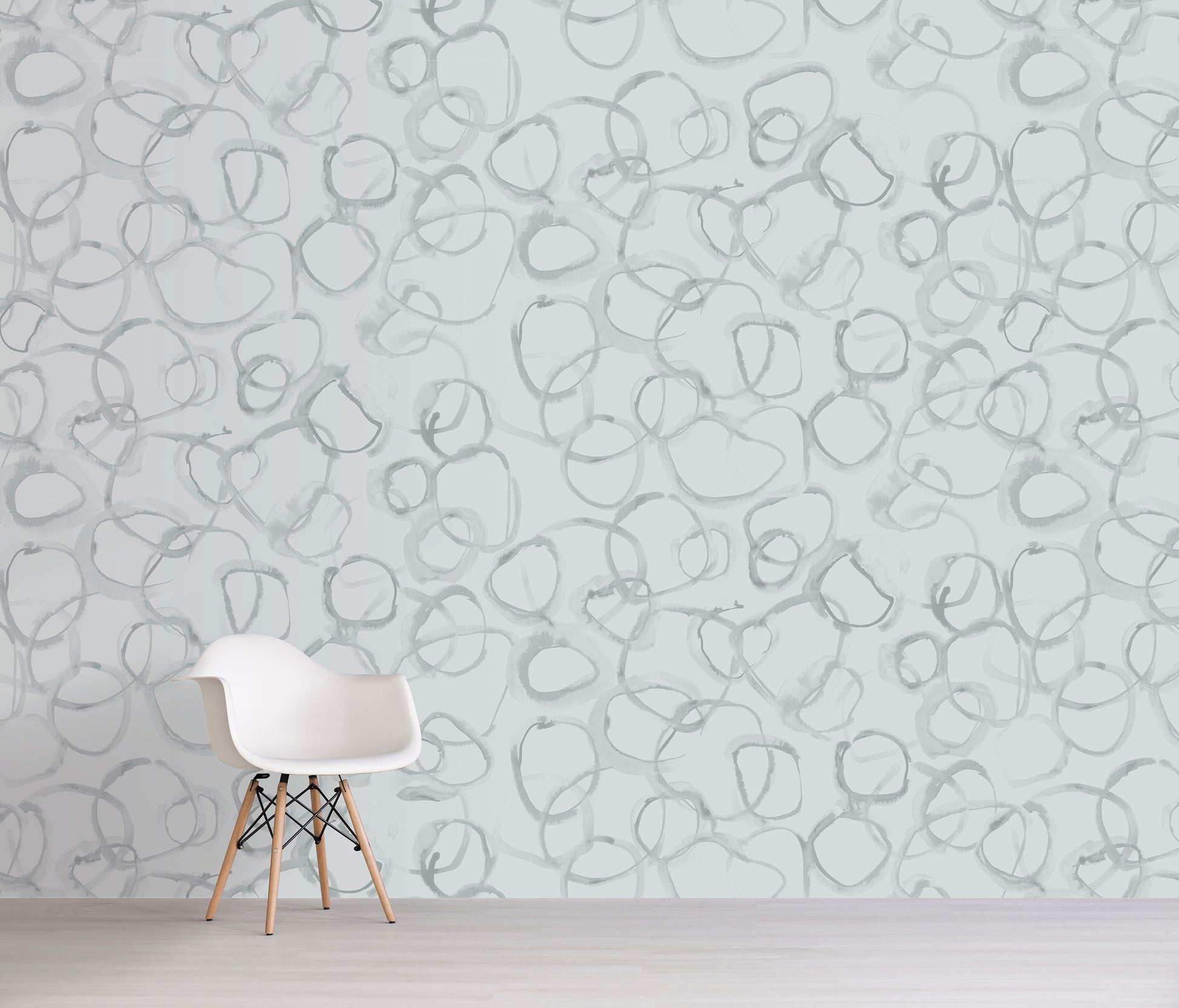 White chair in front of a wall with grey abstract pattern