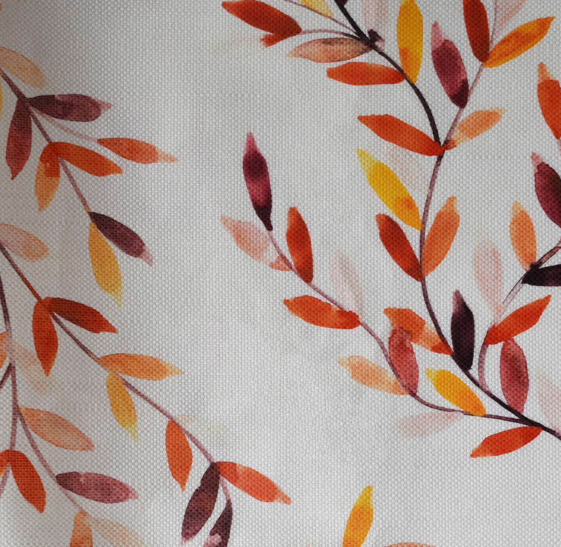 Pattern of autumn leaves on light fabric