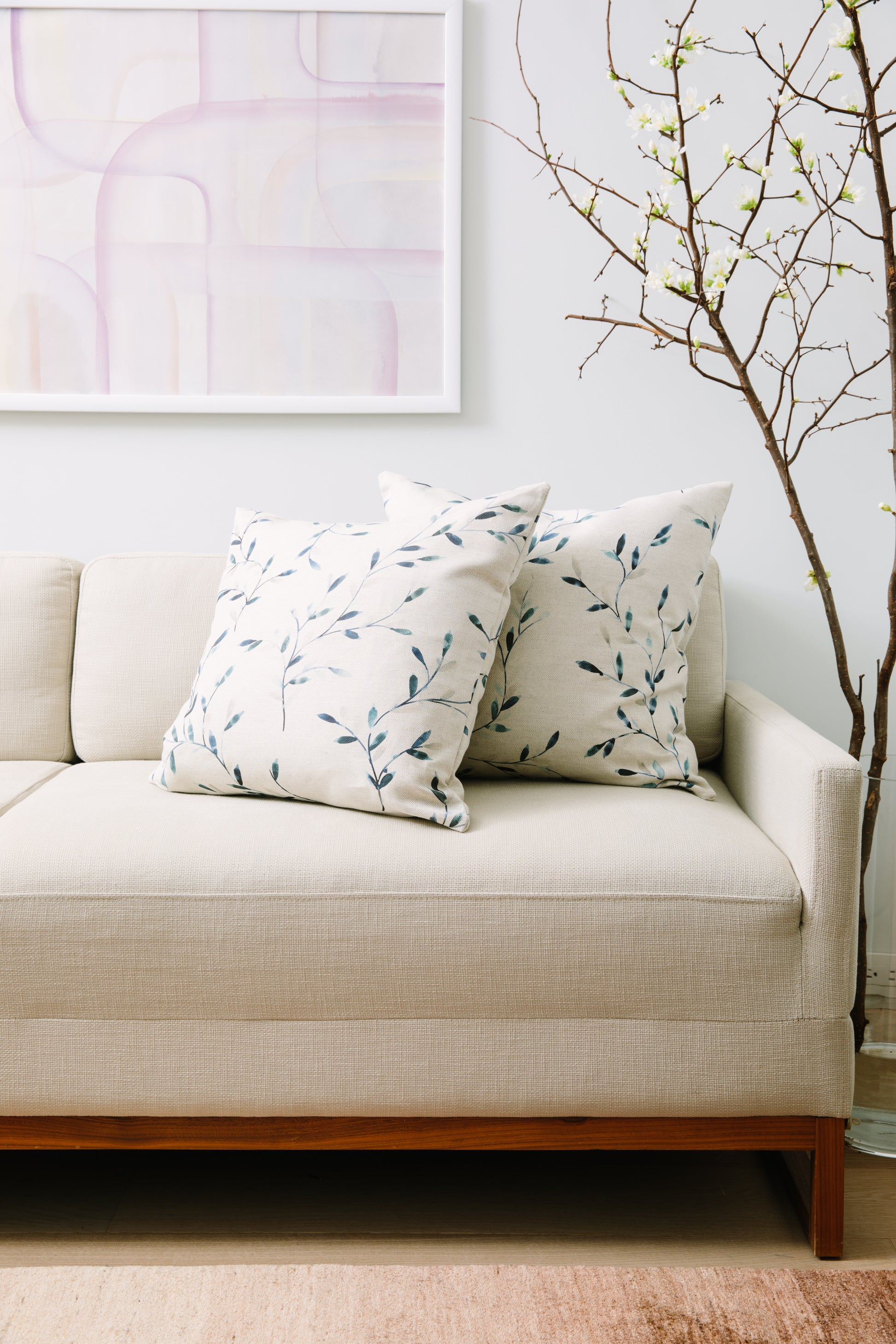 Beige sofa with patterned cushions in a living room setting
