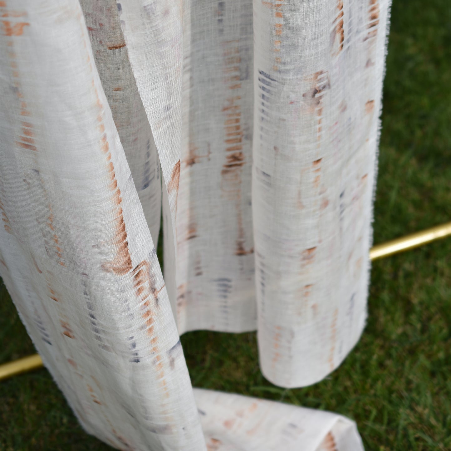 White fabric with brown stains on a grass background