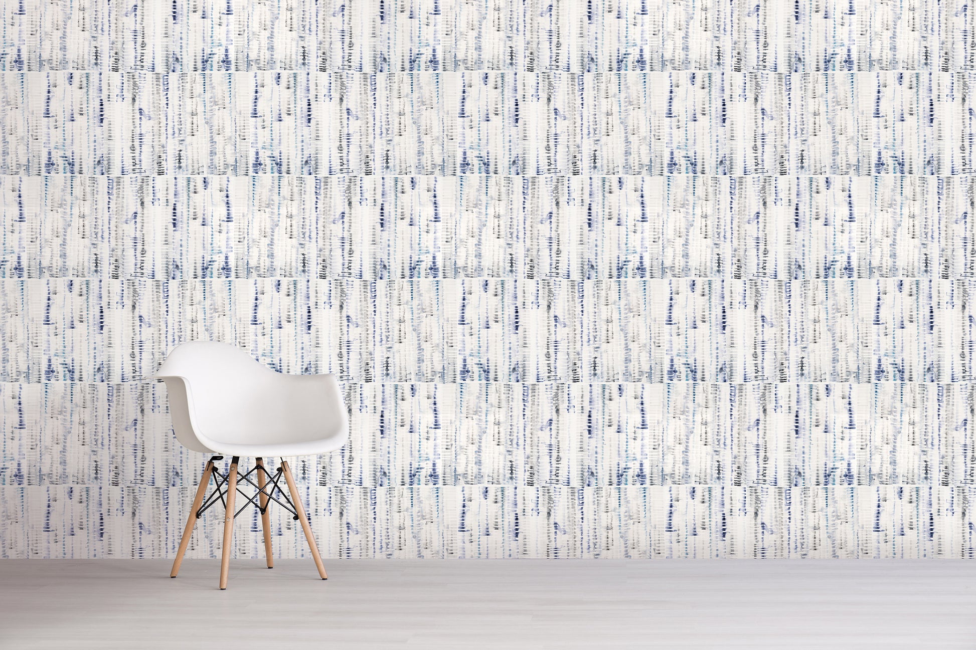 White chair against a textured blue and white wall.