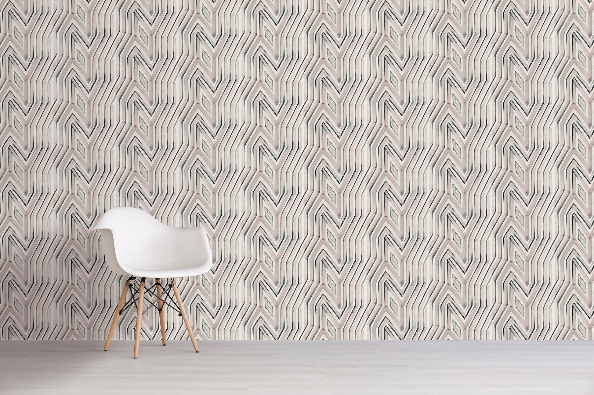 White chair in front of a wall with geometric patterned wallpaper