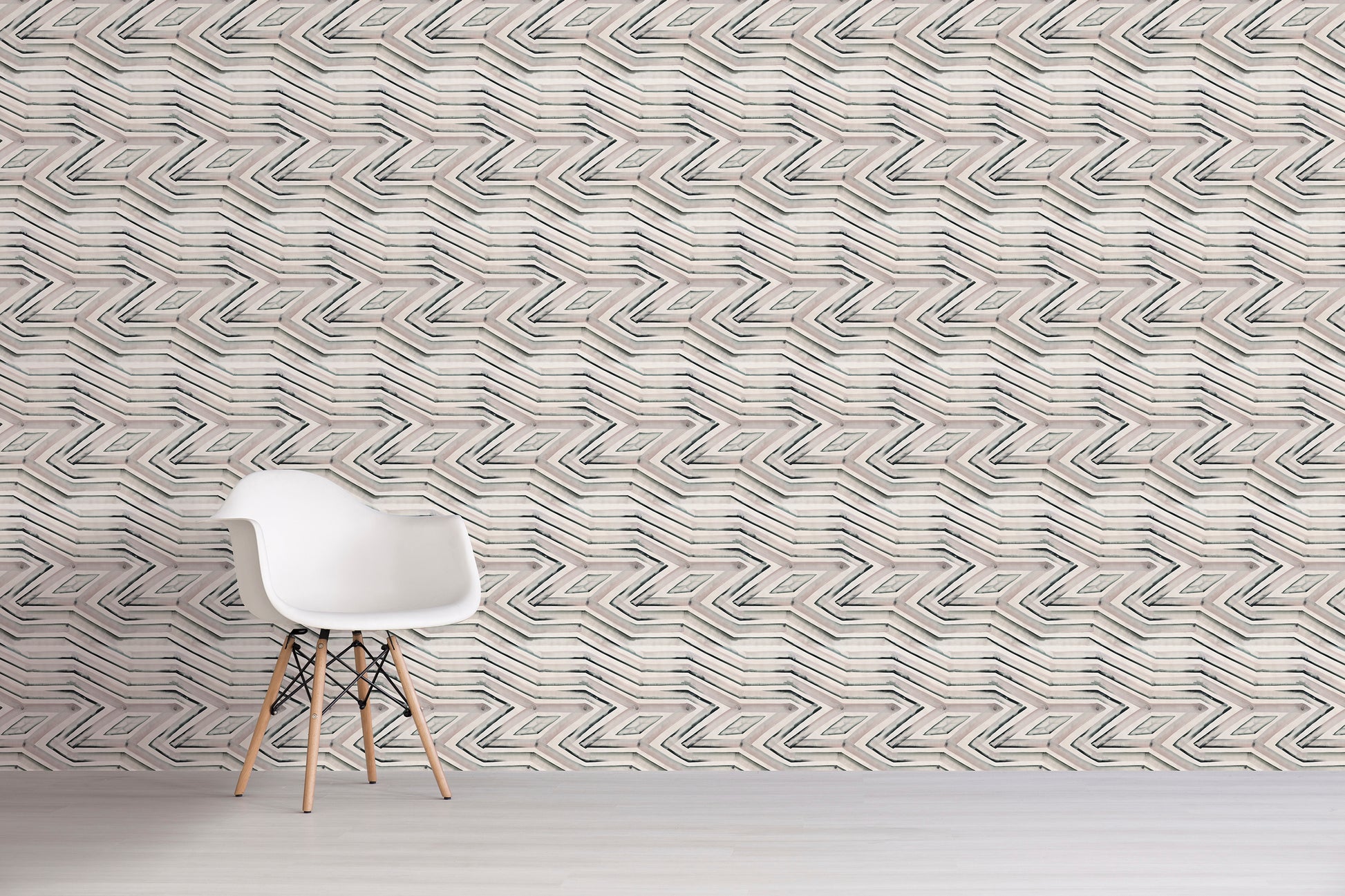 White chair in front of a textured wall with geometric pattern